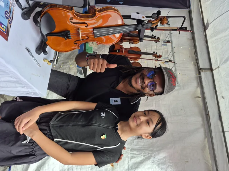 Rahmaan with a young violin student in Da Nang